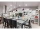 Open kitchen features a granite countertop island with sleek pendant lighting and bar stool seating at 8061 E Lavender Dr, Gold Canyon, AZ 85118