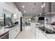 Bright, modern kitchen with white cabinets, granite countertops, stainless steel appliances and ample sunlight at 8061 E Lavender Dr, Gold Canyon, AZ 85118