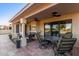 Relaxing covered patio featuring tiled floors, ceiling fans, lounge seating and picturesque backyard views at 8061 E Lavender Dr, Gold Canyon, AZ 85118