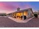 Beautiful shot of the home's rear, showcasing the patio, hardscape, and mountain views at 8061 E Lavender Dr, Gold Canyon, AZ 85118