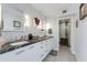 Bathroom featuring dual sinks, white cabinets, granite counters, and a glass shower at 8219 N 3Rd Ave, Phoenix, AZ 85021