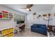Bedroom featuring a desk, TV, sofa, and playful decor, ideal for a study and relaxation at 8219 N 3Rd Ave, Phoenix, AZ 85021