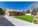Spacious backyard featuring a large covered patio, expansive lawn, and inviting pergola at 8343 W Paradise Dr, Peoria, AZ 85345