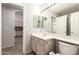 Cozy bathroom with single sink vanity, large mirror, and access to a kitchen on the left at 8343 W Paradise Dr, Peoria, AZ 85345