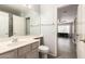 Bathroom featuring a single vanity and toilet, adjacent to the living room, providing convenience at 8343 W Paradise Dr, Peoria, AZ 85345