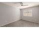 Neutral bedroom with wood-look tile flooring, ceiling fan, and a bright window at 8343 W Paradise Dr, Peoria, AZ 85345