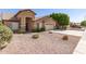 A single-story tan home featuring desert landscaping and a two-car garage at 8343 W Paradise Dr, Peoria, AZ 85345