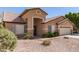 A tan single-story home with a desert rock yard and a tile roof at 8343 W Paradise Dr, Peoria, AZ 85345