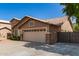 A single-story home with a desert rock yard and a two-car garage at 8343 W Paradise Dr, Peoria, AZ 85345
