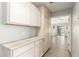 Hallway with lots of cabinets and drawers leading to the living room with backyard view at 8343 W Paradise Dr, Peoria, AZ 85345