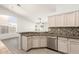 Bright kitchen area showcasing breakfast bar and stainless steel dishwasher at 8343 W Paradise Dr, Peoria, AZ 85345