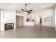 A spacious living room featuring vaulted ceilings, a fireplace, and wood look tile floors at 8343 W Paradise Dr, Peoria, AZ 85345