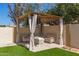 A beautiful backyard pergola features seating and is perfect for outdoor entertaining at 8343 W Paradise Dr, Peoria, AZ 85345