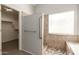 Accessible shower with a built-in bench, grab bars, and an adjacent walk-in closet at 8343 W Paradise Dr, Peoria, AZ 85345