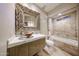 Luxurious bathroom featuring unique mirror and bowl sink, with jetted tub at 8880 E Paraiso Dr # 120, Scottsdale, AZ 85255