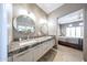 Well lit bathroom featuring double sinks with marble counters and modern fixtures at 8880 E Paraiso Dr # 120, Scottsdale, AZ 85255