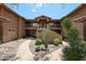 Exterior view of a stucco building with landscaped desert plants and walkway at 8880 E Paraiso Dr # 120, Scottsdale, AZ 85255