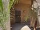 Inviting front entrance with a secure screen door and desert landscaping at 8880 E Paraiso Dr # 120, Scottsdale, AZ 85255