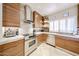 Well-equipped kitchen with stainless steel appliances, white marble countertops, stylish tile backsplash, and custom wood cabinets at 8880 E Paraiso Dr # 120, Scottsdale, AZ 85255