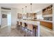 Modern kitchen with stainless steel appliances, marble countertops, and stylish pendant lighting over the breakfast bar at 8880 E Paraiso Dr # 120, Scottsdale, AZ 85255