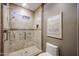 Shower stall featuring tiled walls, glass doors, a shower head, and a grab bar at 8880 E Paraiso Dr # 120, Scottsdale, AZ 85255