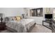 Cozy bedroom with neutral gray color palette, large bed with decorative pillows, and a window for natural light at 10124 E Michigan Ave, Sun Lakes, AZ 85248