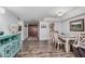 Bright dining room with dark wood floors, table set for four, and entrance view at 10124 E Michigan Ave, Sun Lakes, AZ 85248