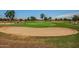 Golf course with a sand bunker in the foreground and green grass in the background at 10124 E Michigan Ave, Sun Lakes, AZ 85248