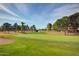Scenic view of lush golf course with manicured lawns and mature trees on a sunny day at 10124 E Michigan Ave, Sun Lakes, AZ 85248