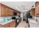Bright kitchen with granite countertops, stainless steel appliances, tile floors and wood cabinets at 10124 E Michigan Ave, Sun Lakes, AZ 85248