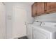 Neat laundry room featuring washer and dryer and door with coded security system at 10124 E Michigan Ave, Sun Lakes, AZ 85248