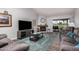 Comfortable living room with fireplace, plush sofas, stylish rug and views of the golf course at 10124 E Michigan Ave, Sun Lakes, AZ 85248