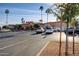 View of parking lot leading to building featuring desert landscaping and palm trees at 10124 E Michigan Ave, Sun Lakes, AZ 85248