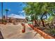 Walkway leading to the community pool and recreation area surrounded by lush landscaping at 10124 E Michigan Ave, Sun Lakes, AZ 85248