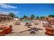 Exterior view of the community pool deck, with lounge chairs and umbrellas at 10124 E Michigan Ave, Sun Lakes, AZ 85248