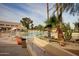 Exterior shot of community swimming pool area featuring desert landscaping at 10124 E Michigan Ave, Sun Lakes, AZ 85248