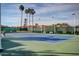 View of outdoor tennis court featuring green and blue surface surrounded by net fencing at 10124 E Michigan Ave, Sun Lakes, AZ 85248
