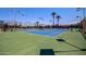Multiple tennis courts with green and blue surfaces, enclosed by a fence and lit by lampposts at 10124 E Michigan Ave, Sun Lakes, AZ 85248