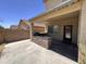 Covered patio and outdoor kitchen area featuring a stone backsplash and concrete floor at 10347 W Odeum Ln, Tolleson, AZ 85353