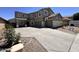 Two-story home features a three-car garage and a long driveway with basketball hoop at 10347 W Odeum Ln, Tolleson, AZ 85353