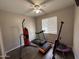 Bright gym with wood floors, neutral walls, ceiling fan, and various equipment at 10347 W Odeum Ln, Tolleson, AZ 85353