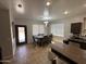 Open-concept kitchen and dining area features an island with barstool seating and dining table at 10347 W Odeum Ln, Tolleson, AZ 85353