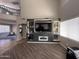 Bright living room features a soaring ceiling and a modern entertainment center at 10347 W Odeum Ln, Tolleson, AZ 85353
