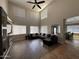 Bright living room features a soaring ceiling, large windows, and stylish decor at 10347 W Odeum Ln, Tolleson, AZ 85353