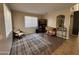 Cozy living room with neutral colors, a patterned rug, and stylish decor at 10347 W Odeum Ln, Tolleson, AZ 85353