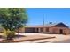 Well-maintained single-story brick home with attached two-car garage and mature trees for shade at 1103 E Palmcroft Dr, Tempe, AZ 85282