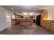 Bright kitchen featuring wooden cabinets, granite countertops, an island, and modern black appliances at 1103 E Palmcroft Dr, Tempe, AZ 85282