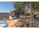 View of brick patio and backyard with a shed along the side of the home at 1123 W Mendoza Ave, Mesa, AZ 85210