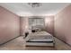Bedroom showing tan floors, ceiling fan, a lamp and a bed with a decorative headboard at 1123 W Mendoza Ave, Mesa, AZ 85210