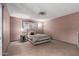 Bedroom with tan floors, ceiling fan, and a bed with a decorative headboard and a lamp at 1123 W Mendoza Ave, Mesa, AZ 85210